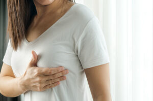 Woman examining her breast - women's health concept