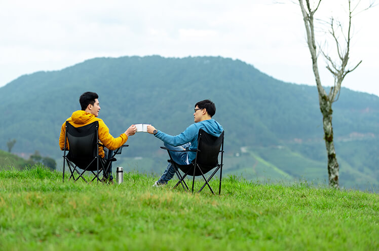 Youngsters enjoying tea and embracing wellness amidst scenic hills