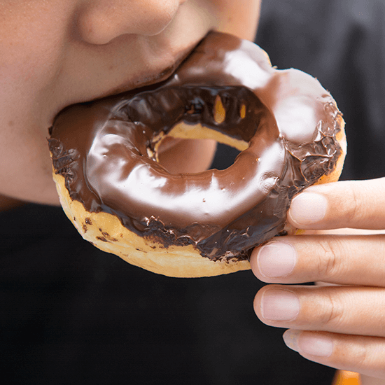 Man Eating Donut - Image Implies Diet Management for Diabetes