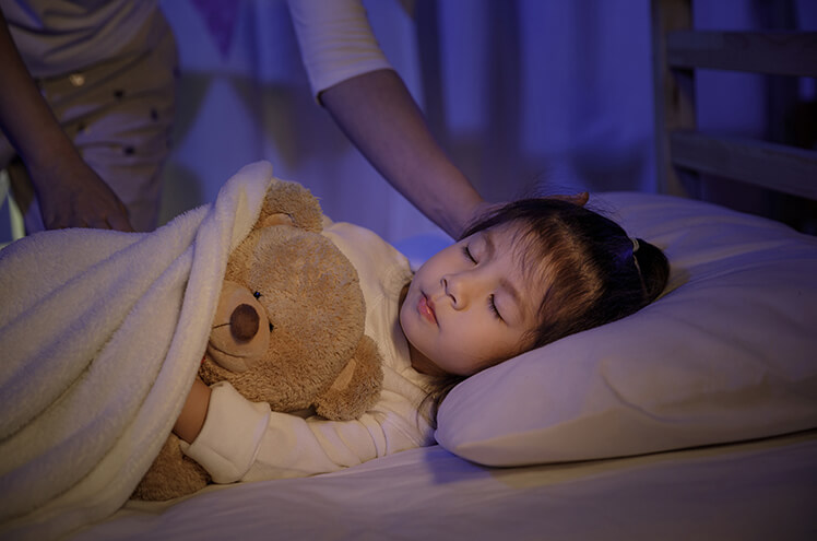 Cute baby sleeping with teddy bear