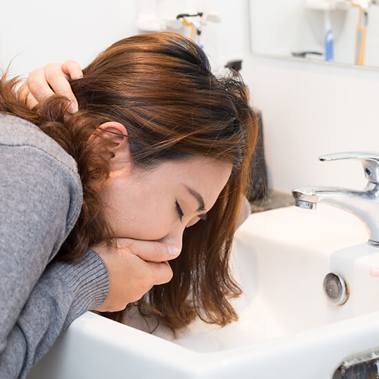 Young girl vomiting - women's health concept
