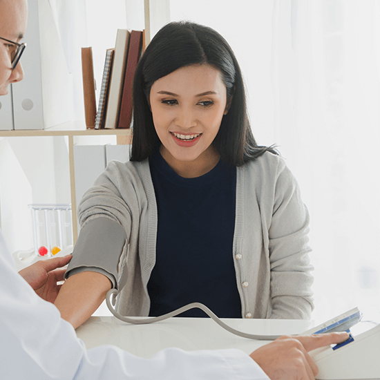 A doctor checking the blood pressure of a patient