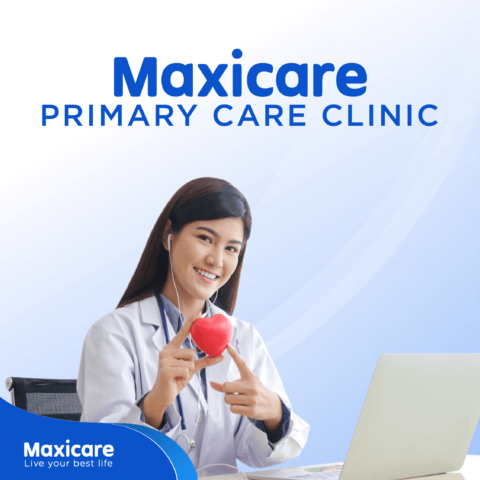 Maxicare doctor holding and pointing at a heart