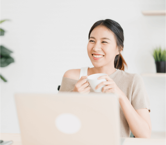 Image of a Woman with Her Coffee and Laptop Implying Dealing with Mental Health