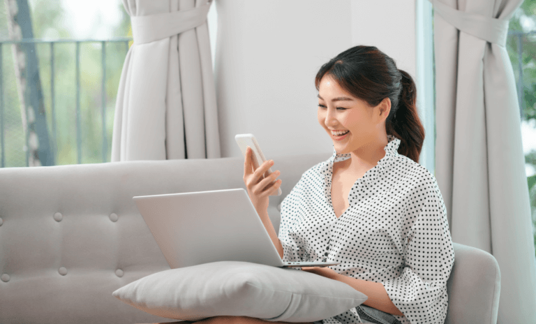 resources-banner-mobile-png Girl holding mobile and laptop on a pillow